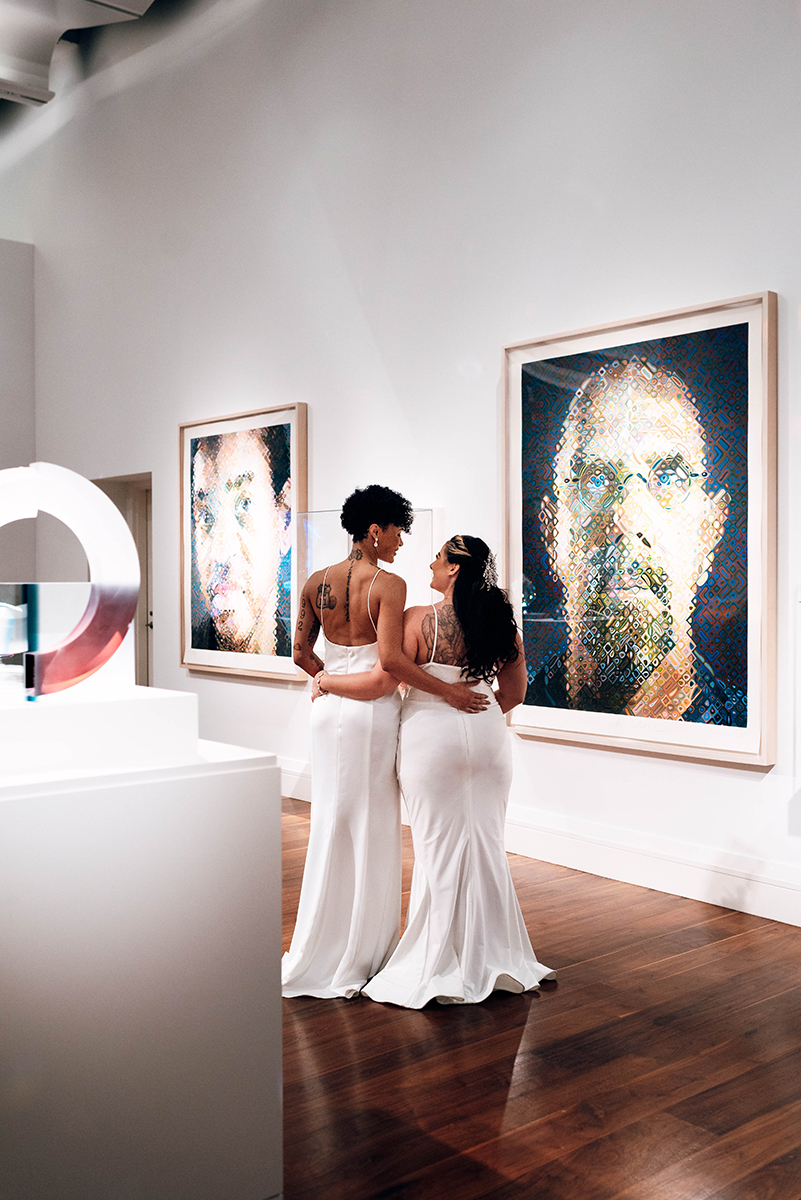 Wedding styled shoot at 220 North Tryon in Charlotte, NC and Foundation of the Carolinas art gallery. Couple in art gallery viewing painting on wall