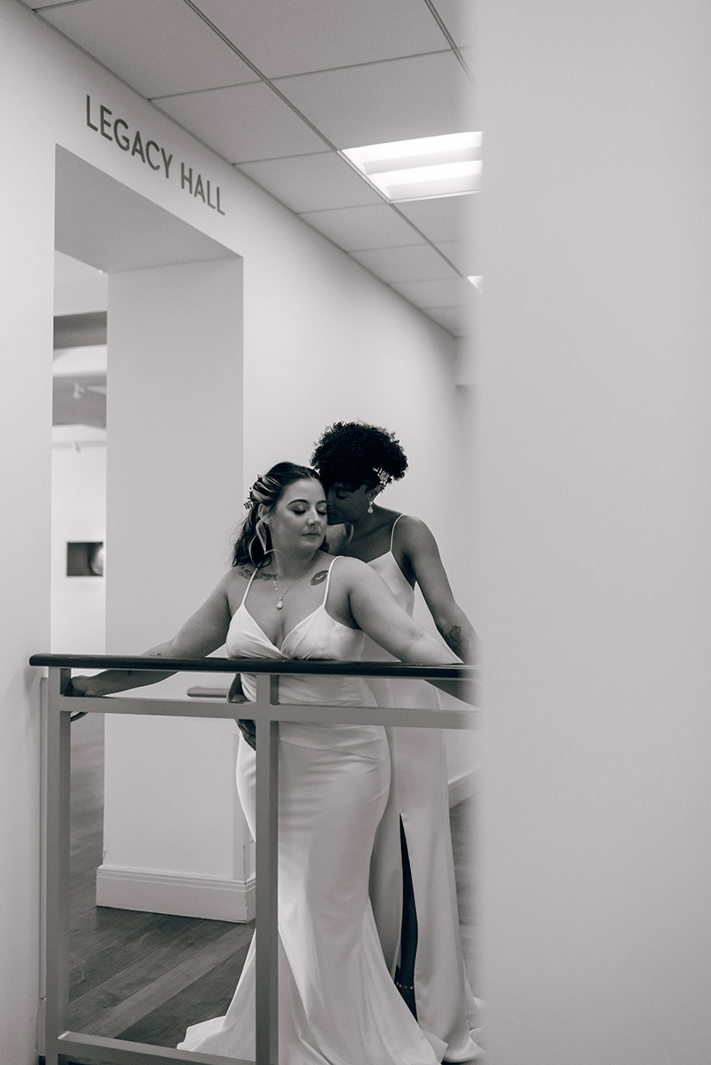 Wedding styled shoot at 220 North Tryon in Charlotte, NC and Foundation of the Carolinas art gallery. Couple leaning over ramp railng