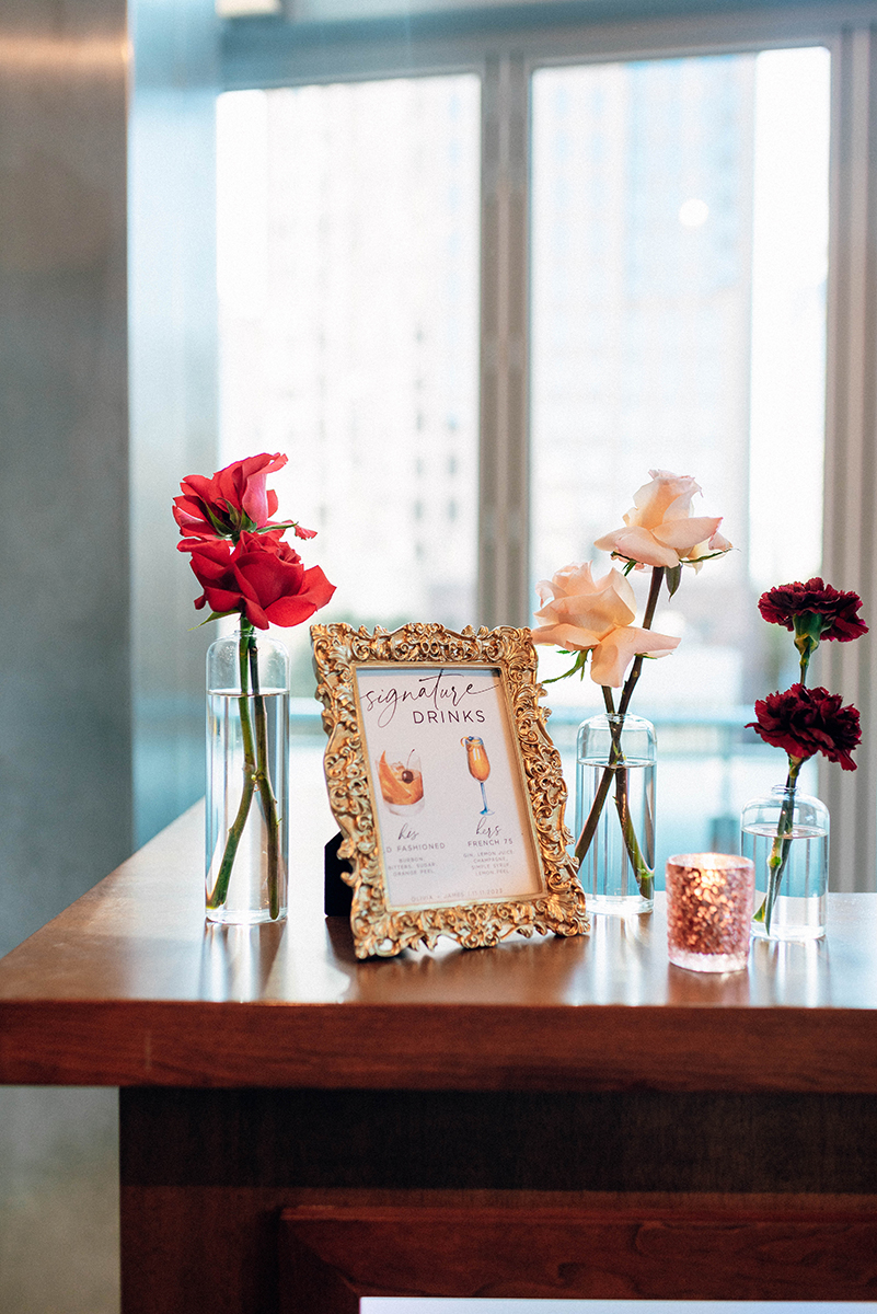 Wedding styled shoot at 220 North Tryon in Charlotte, NC and Foundation of the Carolinas art gallery. Image of drink menu and flower decor close up