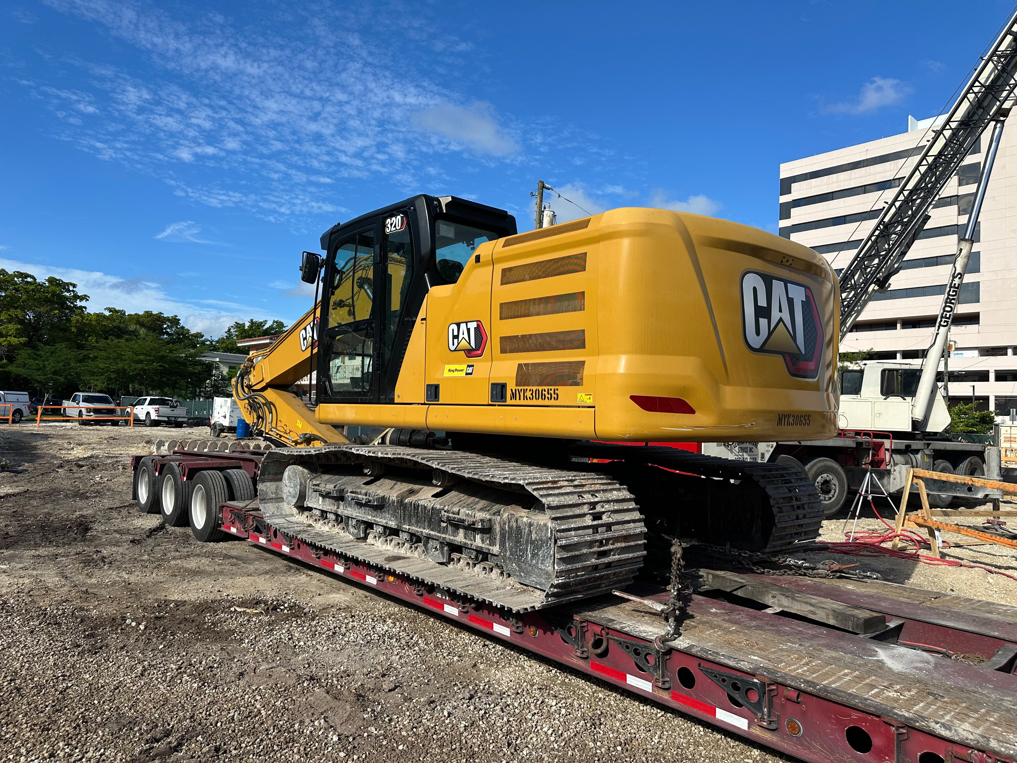 One CAT 320 excavator weighing 50,000 lbs, measuring 32' L x 9'8" W x 9'7" H, transported safely on a lowboy trailer.