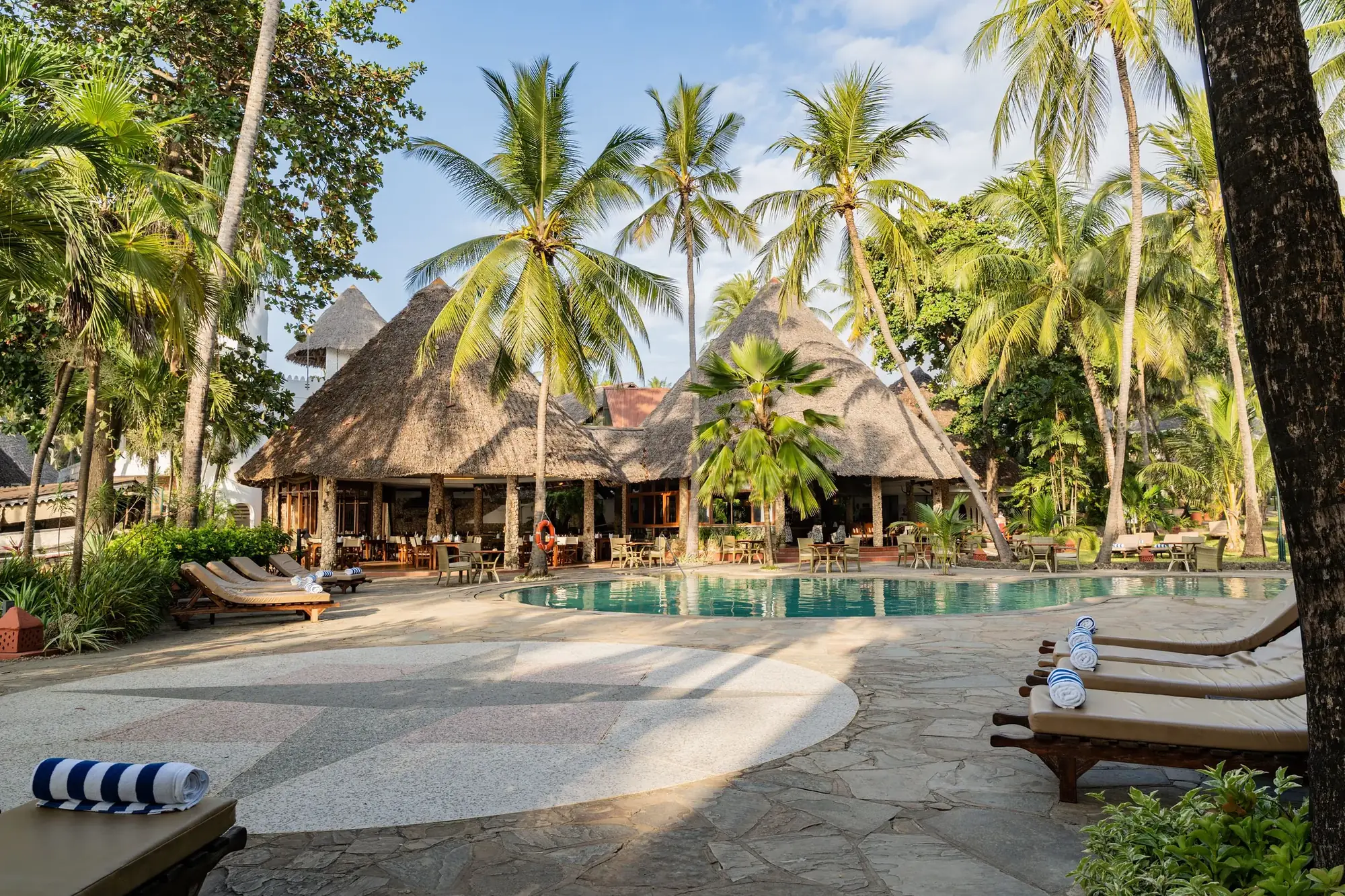 Pool area with sun loungers in the tropical garden