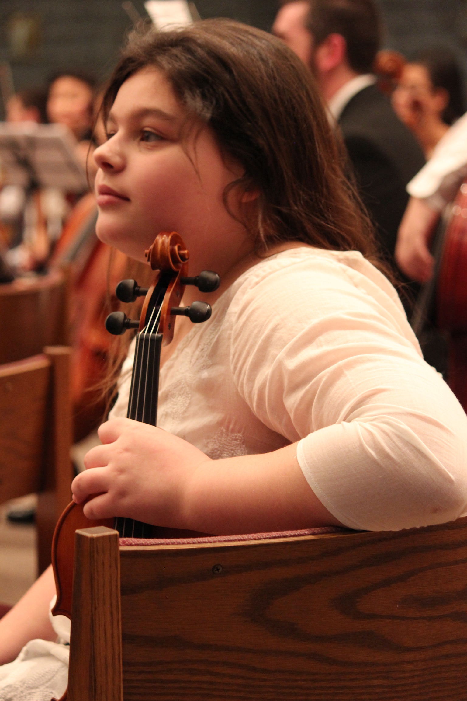 A young Georgia (age 9) with her violin looking into the distance.
