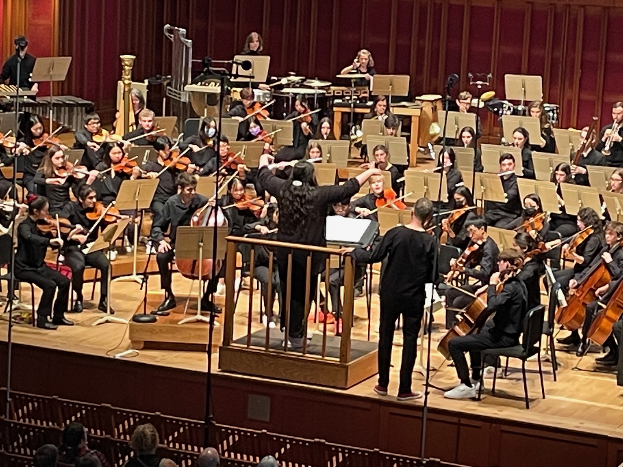 Georgia conducting the ESYO t Ozawa Hall in Tanglewood at her final concert with the orchestra.