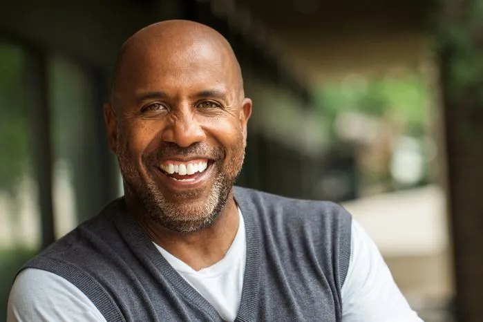 A view of a smiling man showing strength and resilience while living with mental health challenges