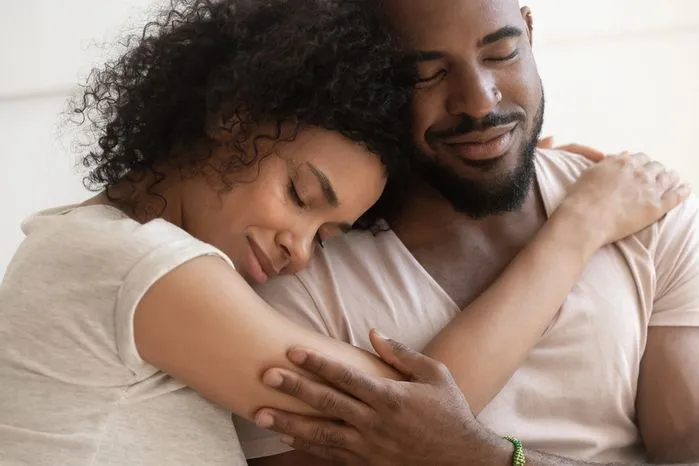 An image of a loving couple embracing with eyes closed — learn the key differences between compassion vs empathy.