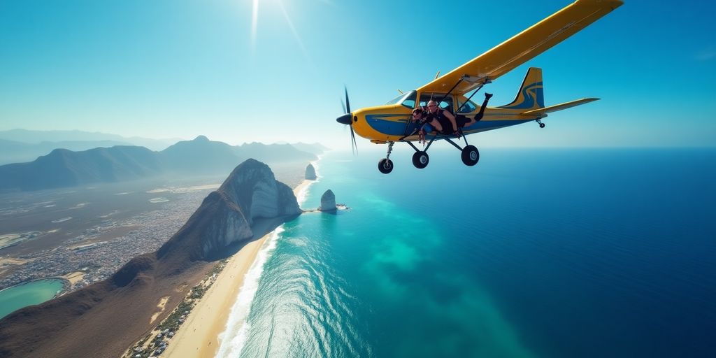 Skydiver above Cabo with ocean and beaches below.