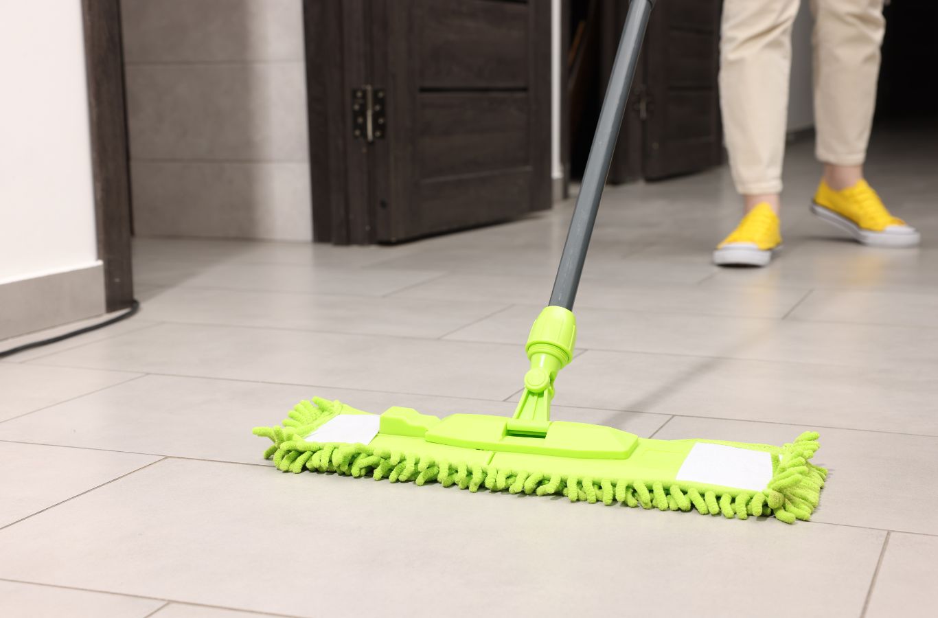 A Sapphire Home Cleaning professional cleaning hardwood floors in a Chicago, IL Airbnb, highlighting pristine surfaces as part of expert Airbnb cleaning services.