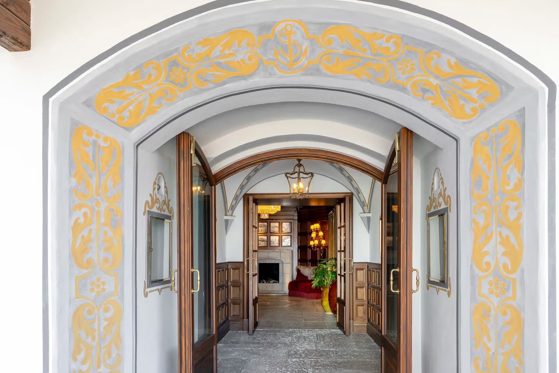 Entrada principal do hotel com arco decorado em ouro e cinza