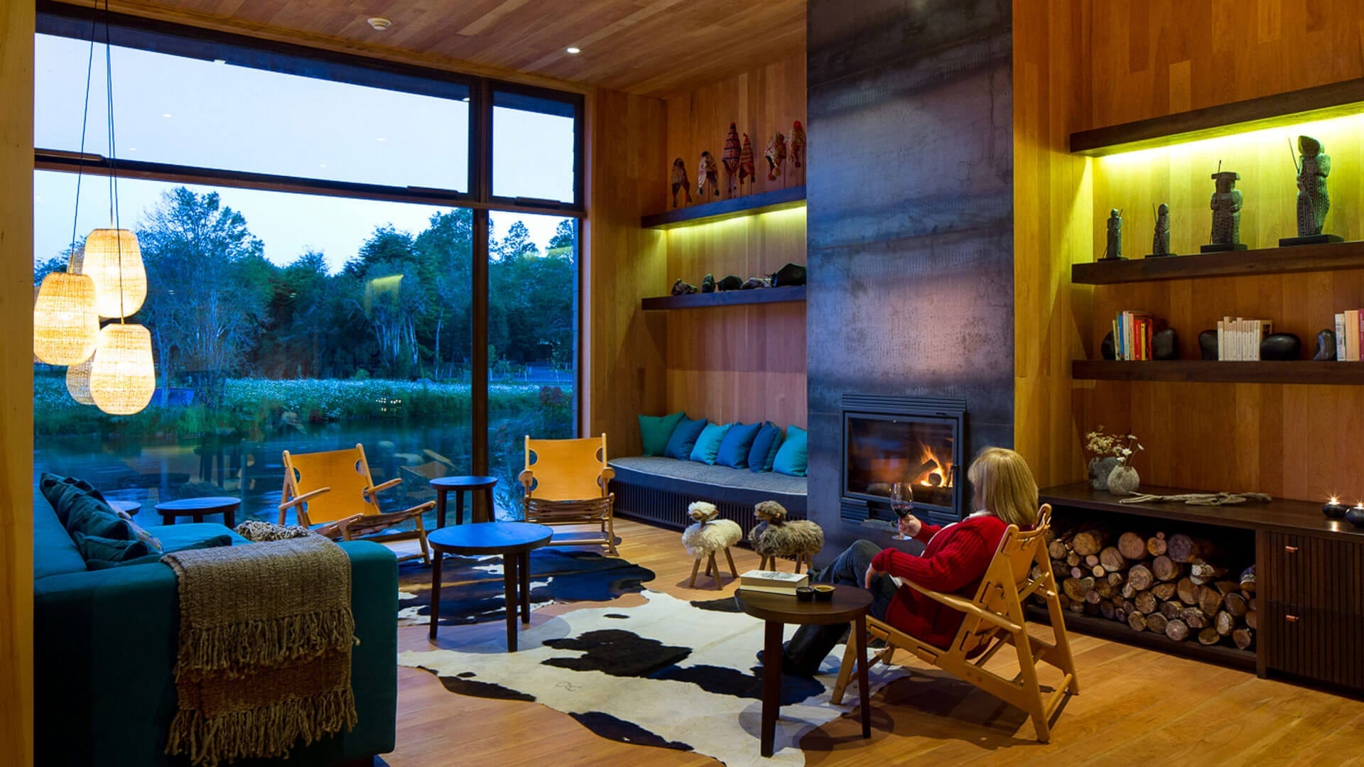 Sala de estar com lareira, decoração colorida e vista para o jardim
