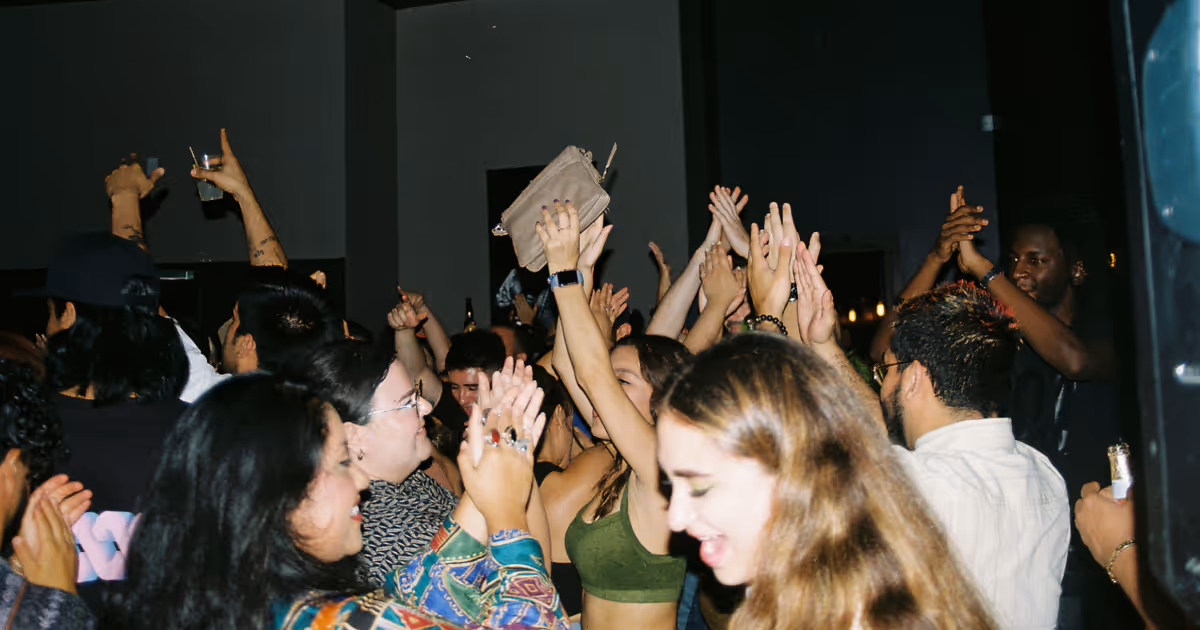 Group of people applauding, hands in the air