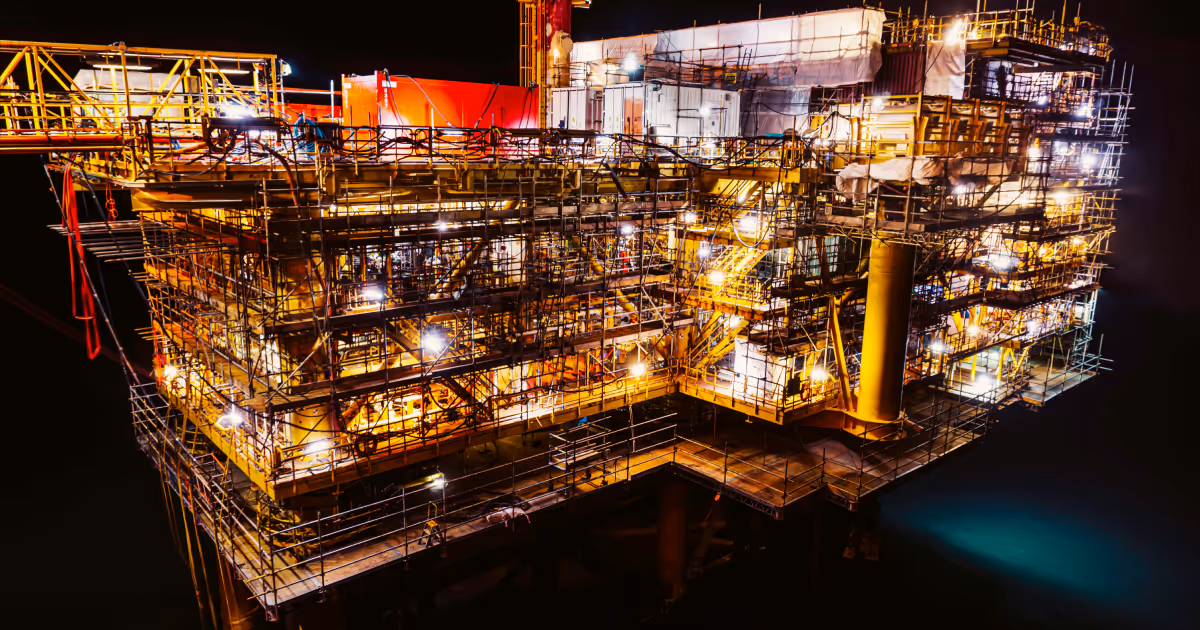 Large oil rig lit up in the dark