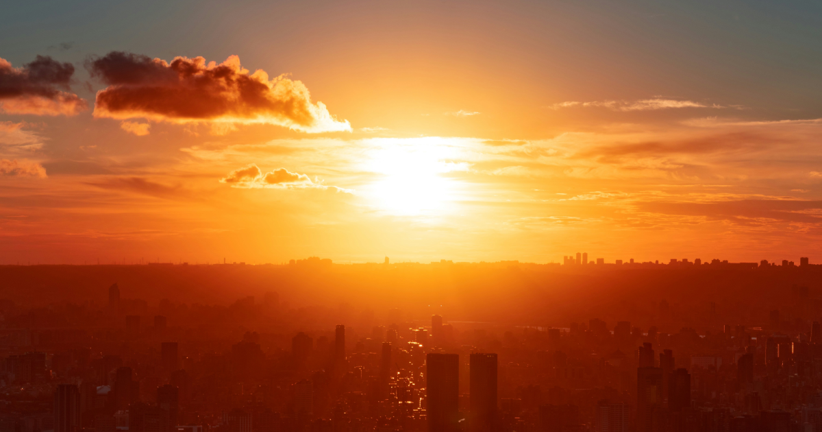 Sun rising over metropolis