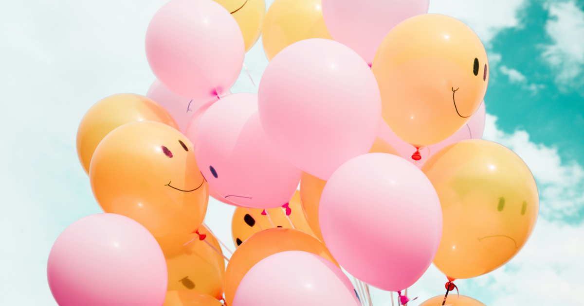 Bunch of colourful balloons, with smiley faces