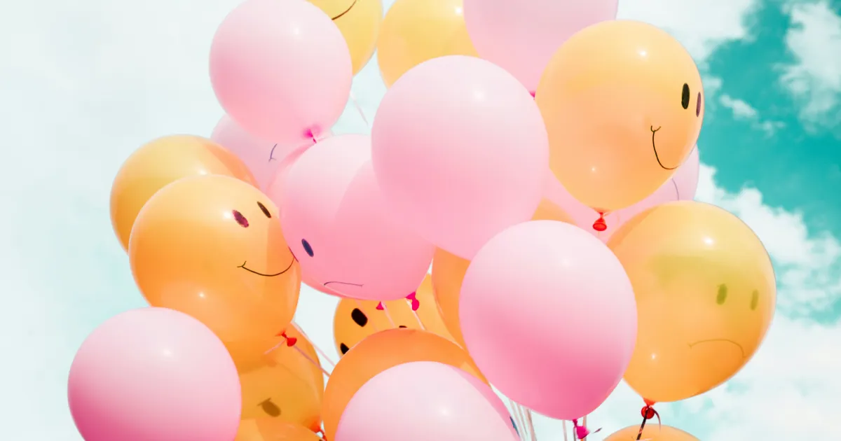 Bunch of colourful balloons, with smiley faces