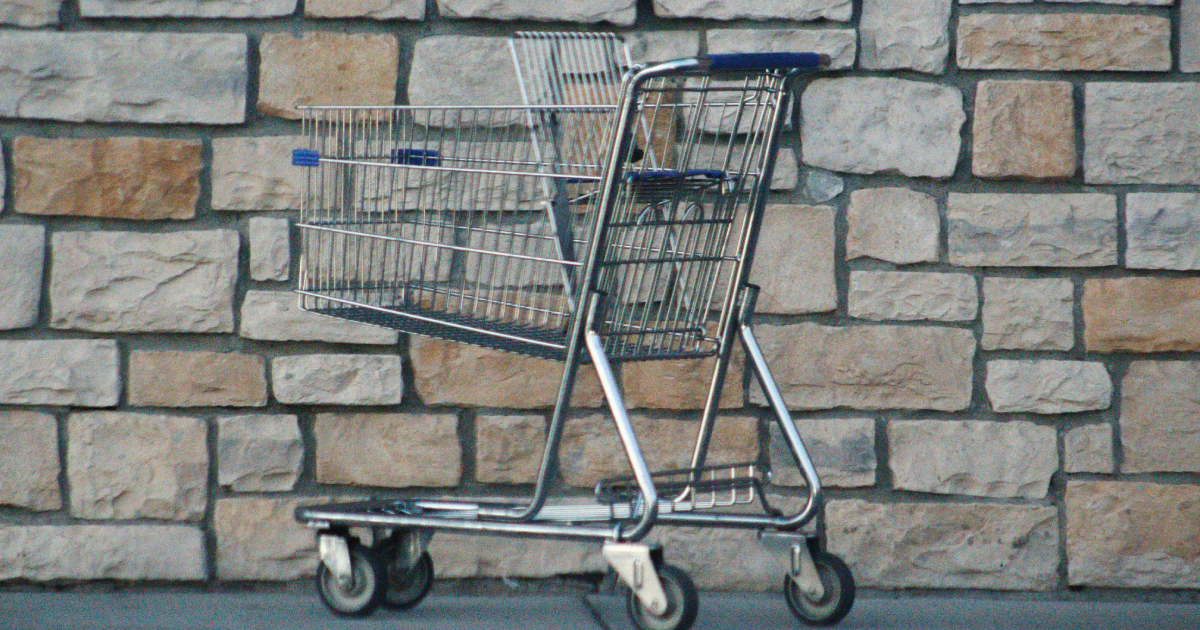 Empty shopping trolley standing alone