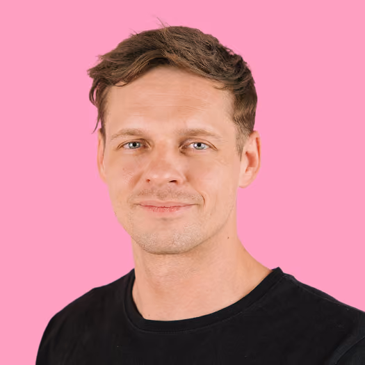 Portrait of Rory, Director of Growth and Marketing at Freetrade, on a pink background.