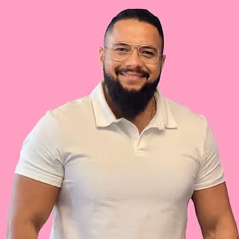 Portrait of Sami, Director of Security, Privacy and IT at Freetrade, on a pink background.