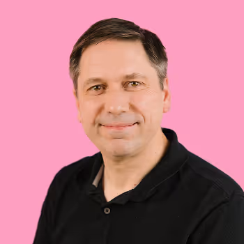 Portrait of Tony, Director of Product at Freetrade, on a pink background.