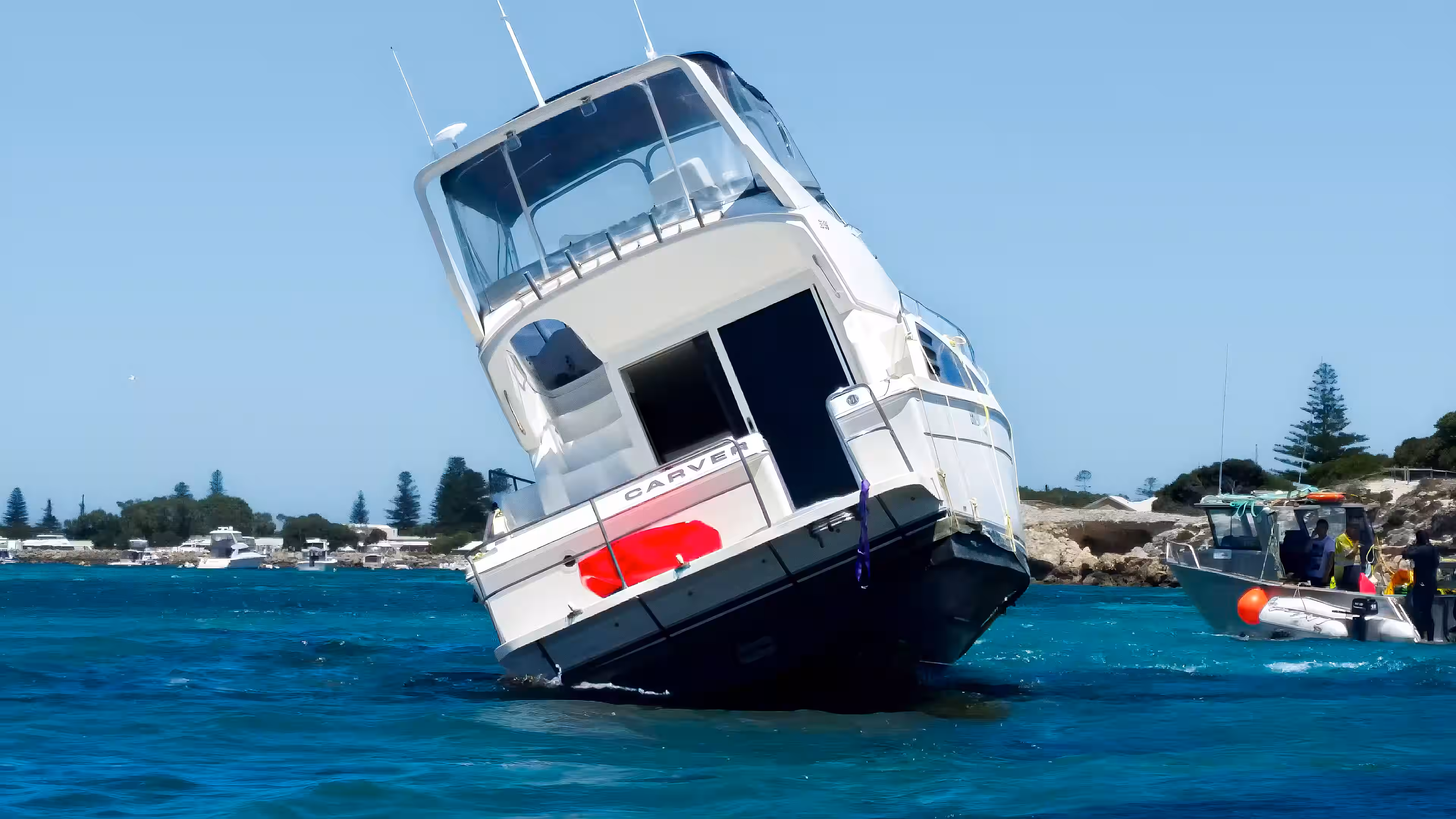 Motor yacht grounded on a reef in shallow coastal waters