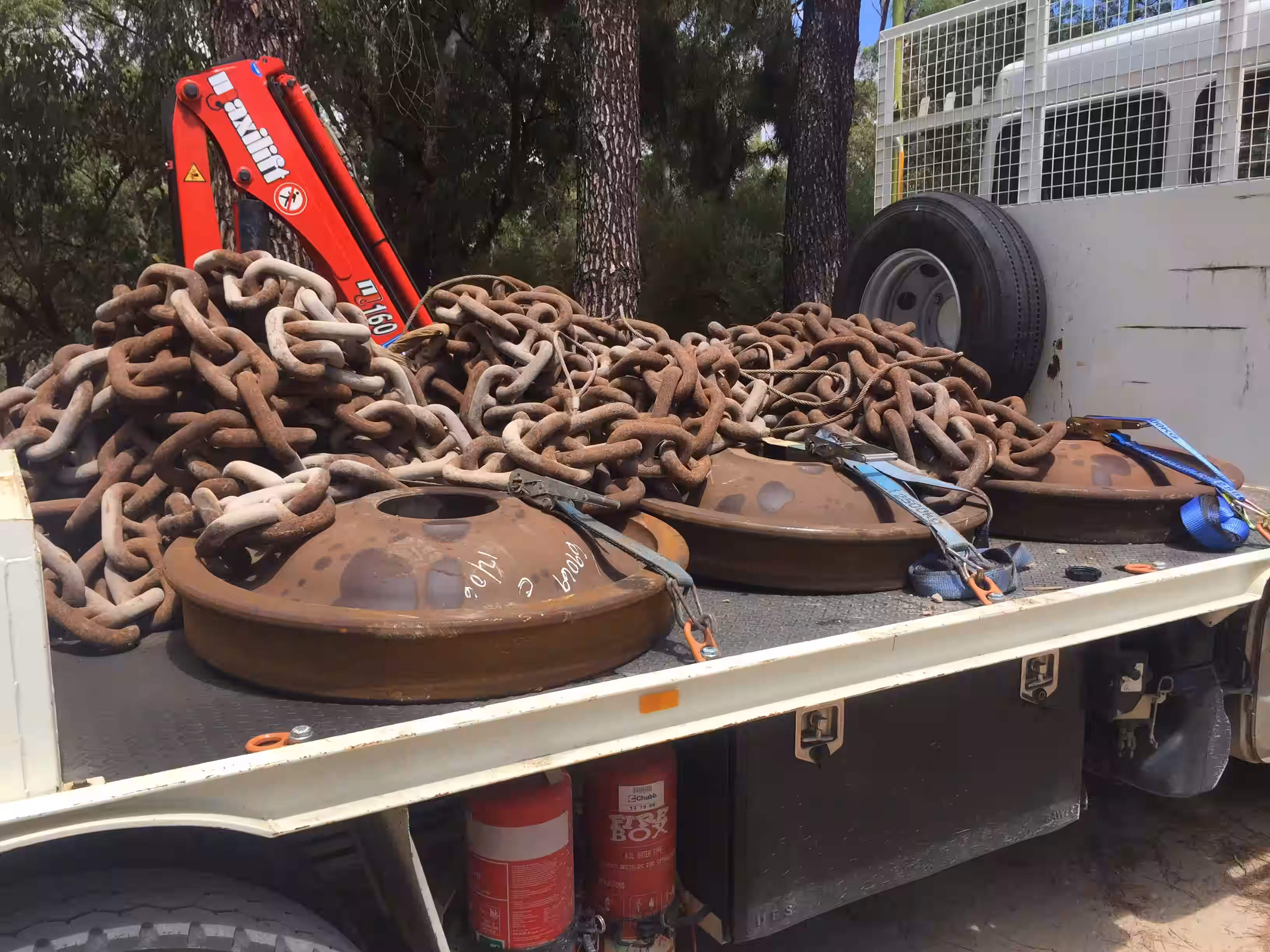 Mooring chains and anchor weights secured on a transport truck