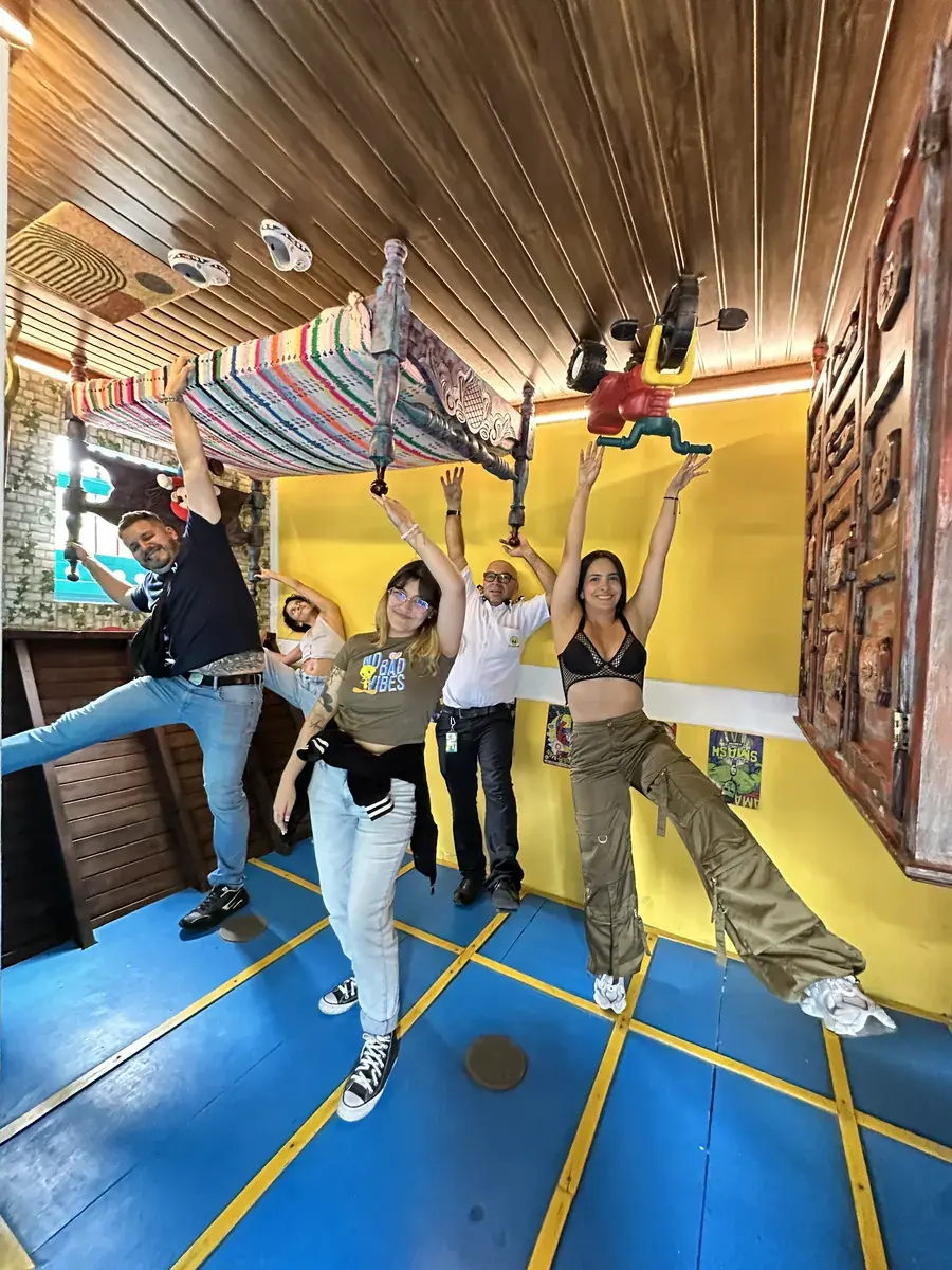 Team having fun at an upside-down house experience