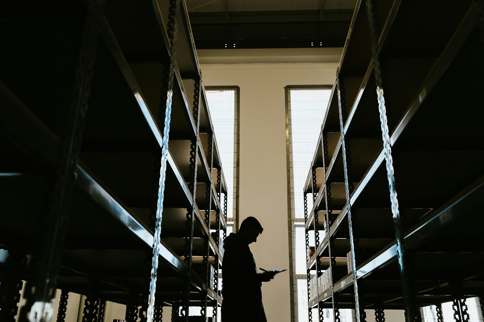 Person conducting inventory management in a warehouse.