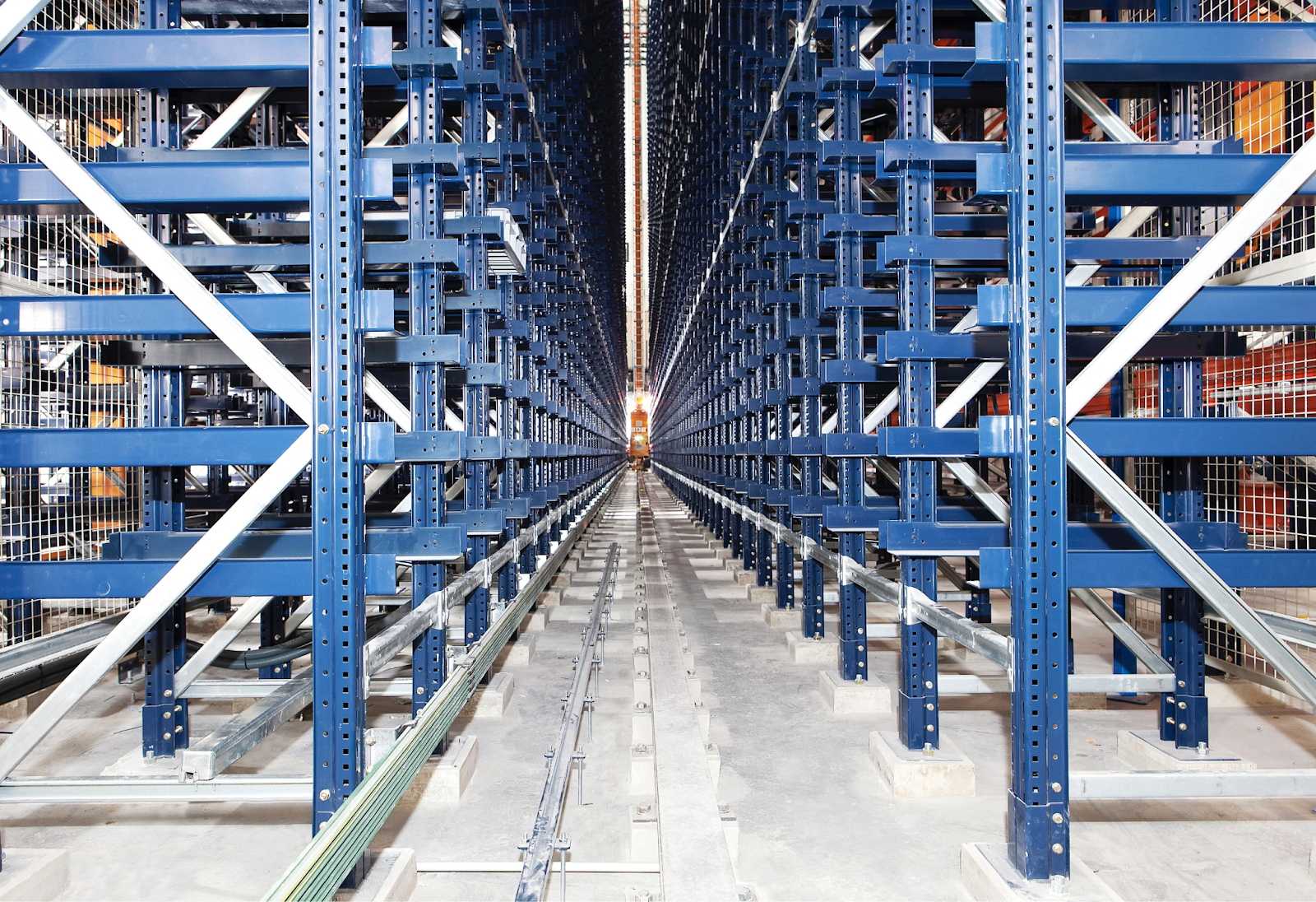 A long hallway, lined with blue racks of inventory.