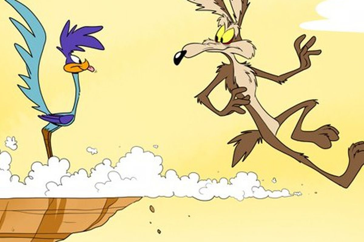 A still of Wile E. Coyote chasing the road runner off a cliff.