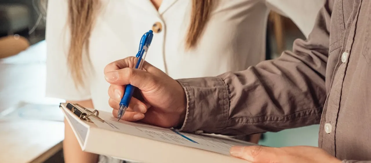 man signing a document - How To Dissolve An LLC In Maryland