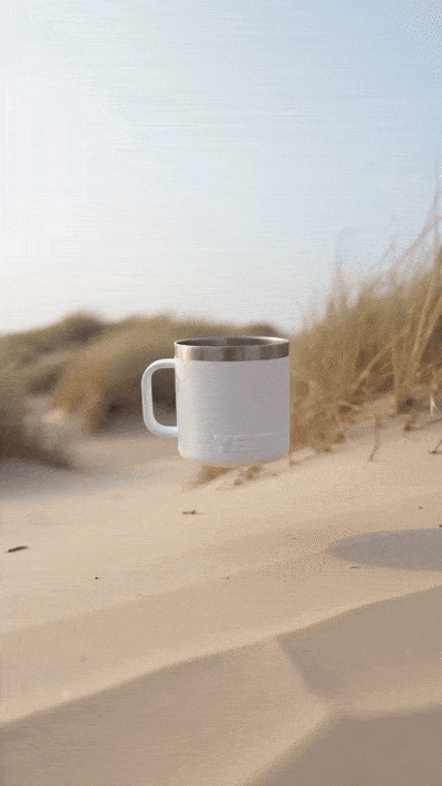 AI-generated scene of a Yeti coffee mug floating above sand dunes