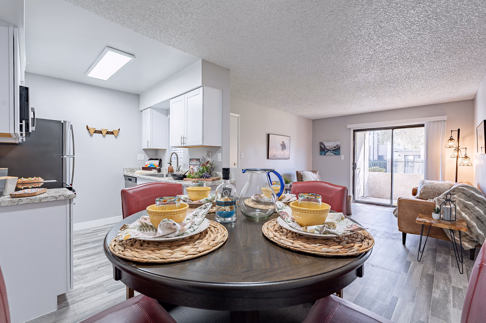 Dining area with table and view of Living area with sofa and view of patio 