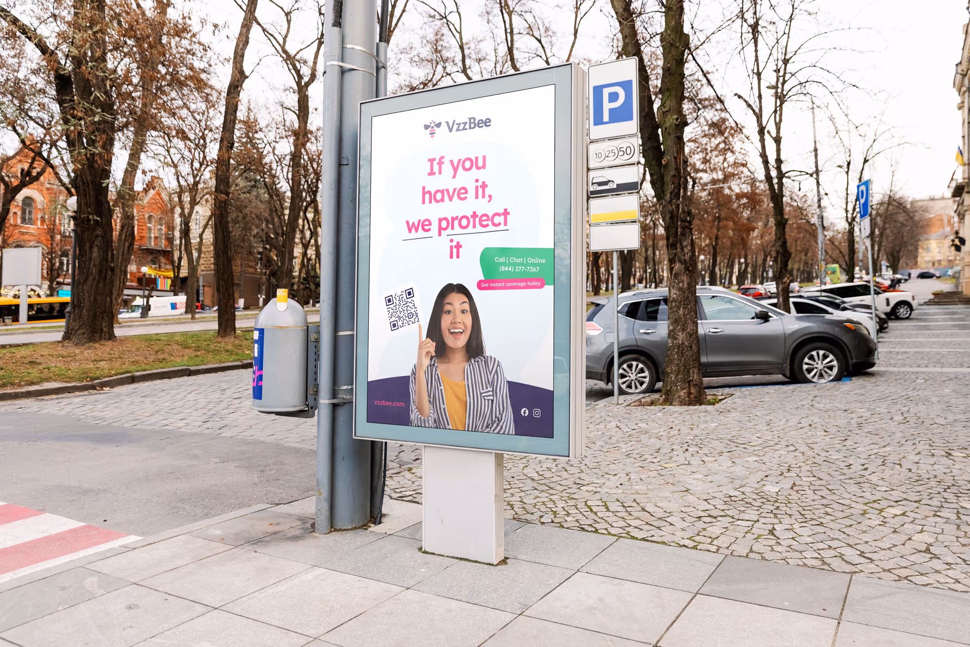 Outdoor advertising display featuring an ad with a cheerful woman, promoting vehicle protection services alongside a QR code for easy access.