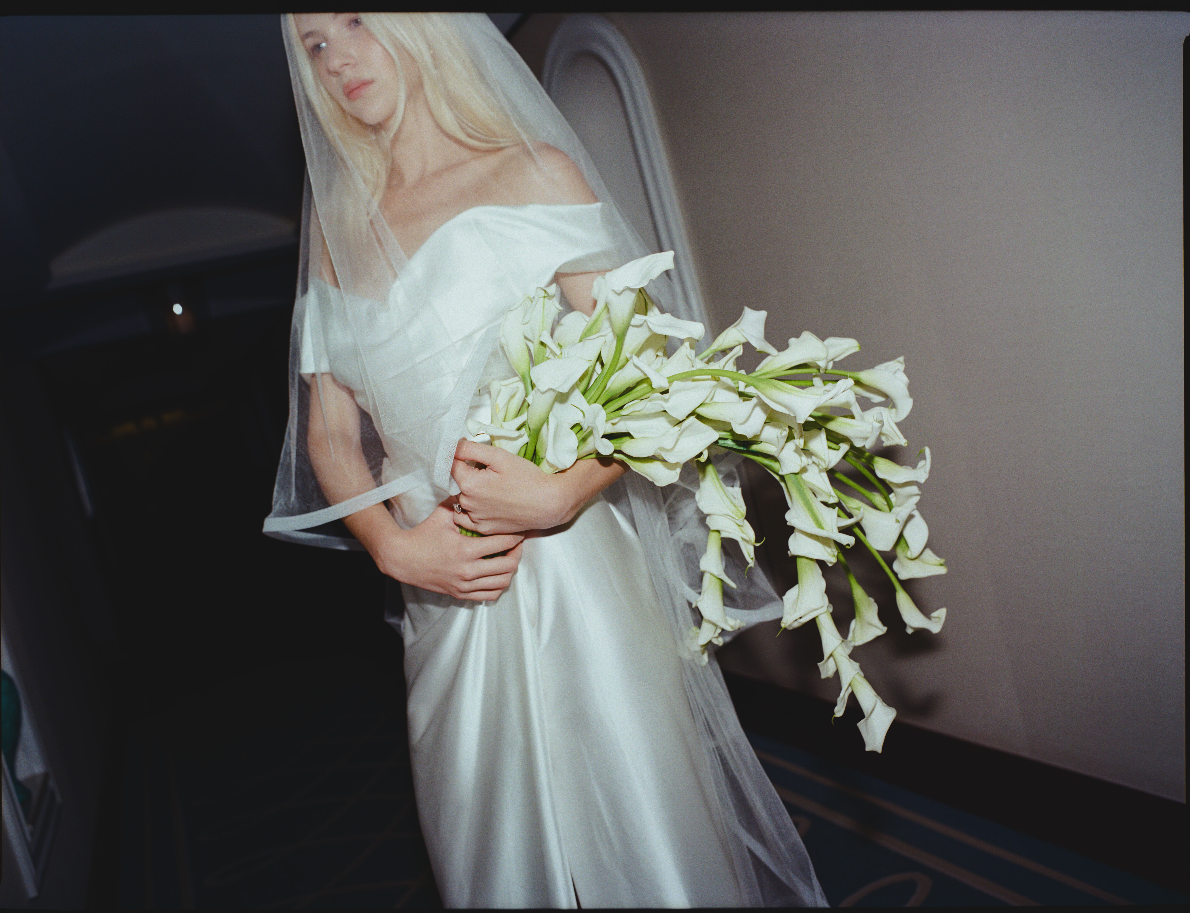 Bride and bridesmaids holding bouquets of flowers by Mrs Gibbons