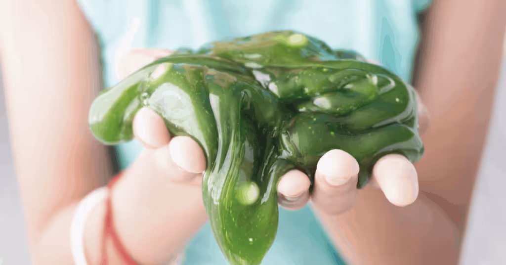 child holding green slime