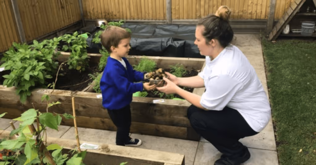 chef and child growing vegetables at Horley nursery