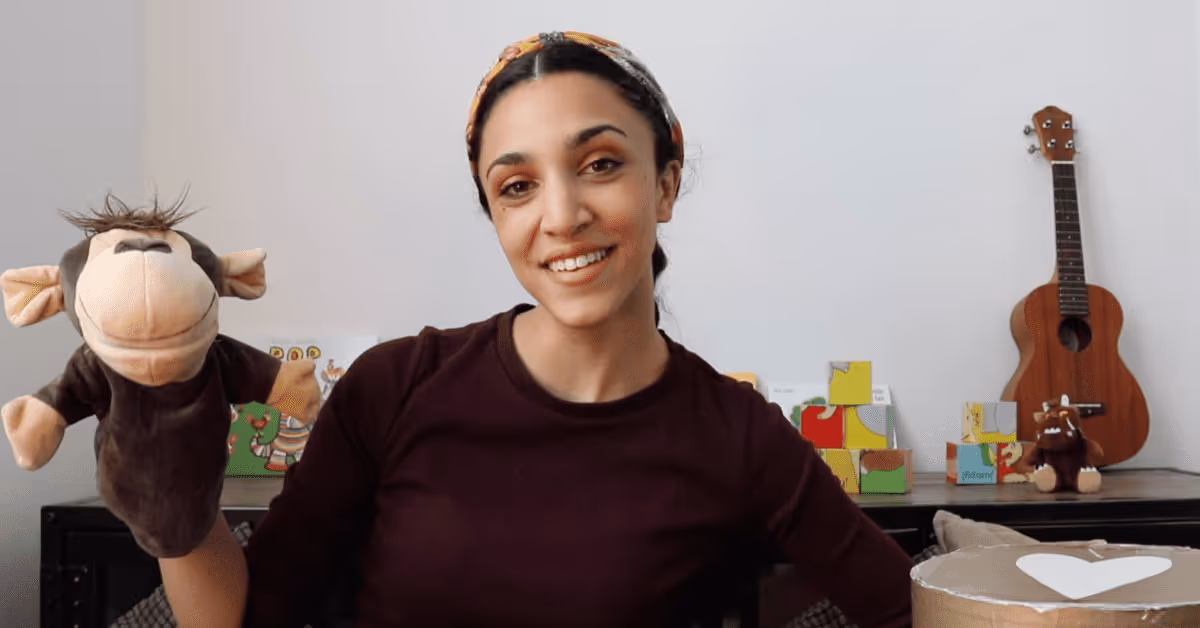French teacher holding puppet at nursery