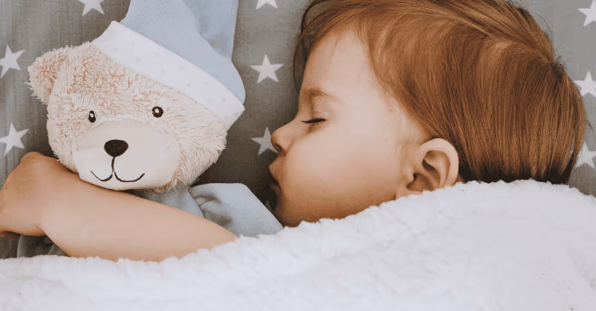 baby sleeping with teddy bear