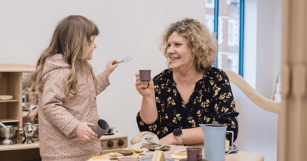 early years teacher role play activities with child