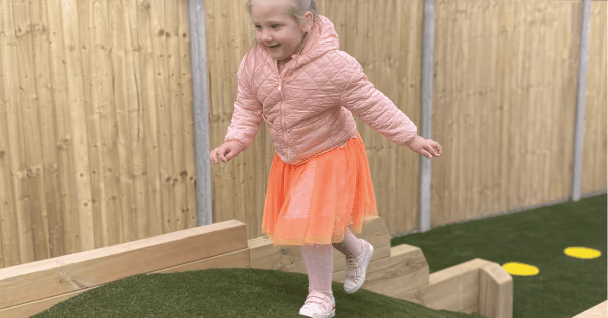 child running over hill in nursery garden