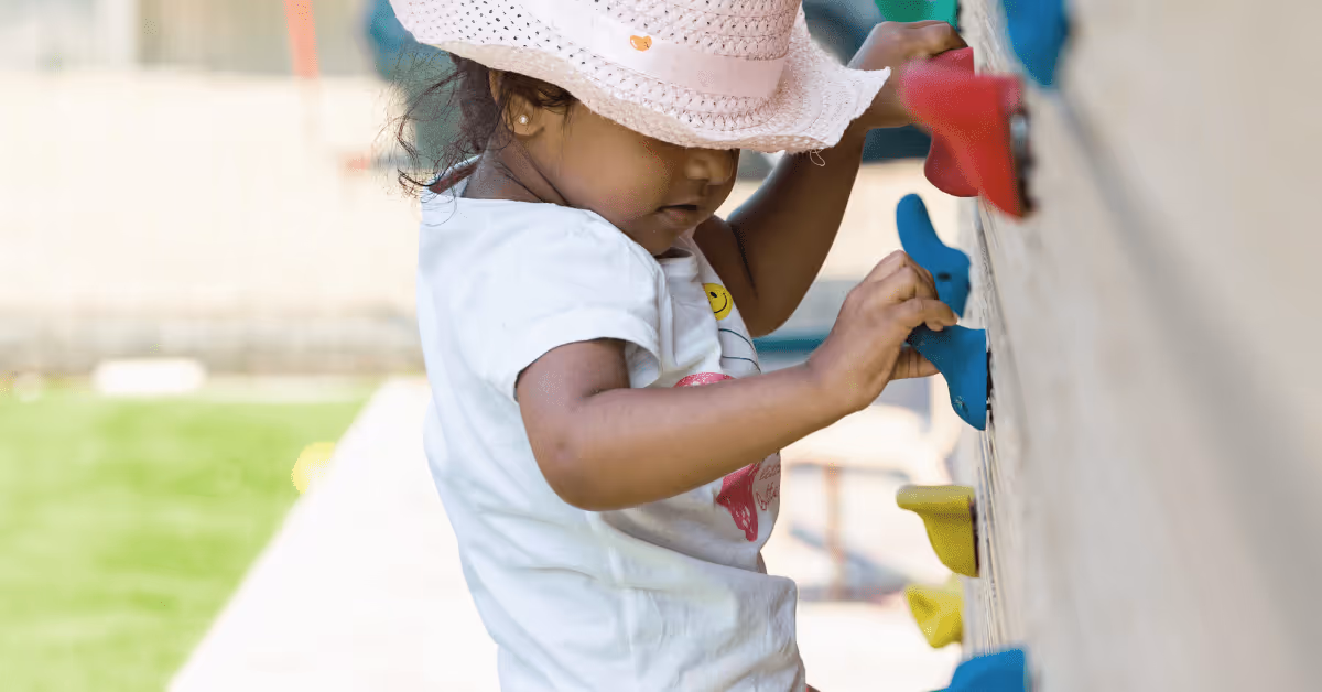 child climbing wall at fennies woking nursery