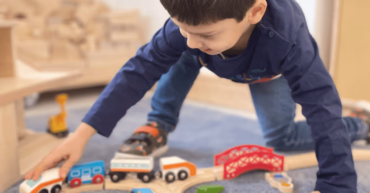 child playing with toy car in nursery