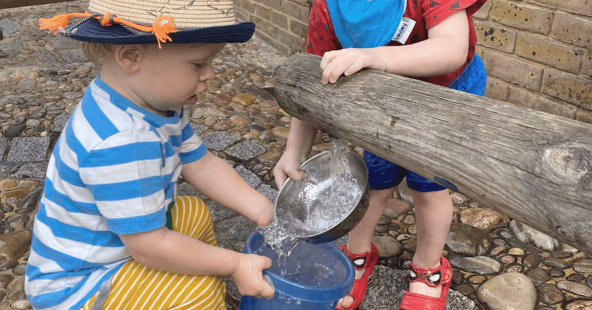 children playing with water in nursery garden