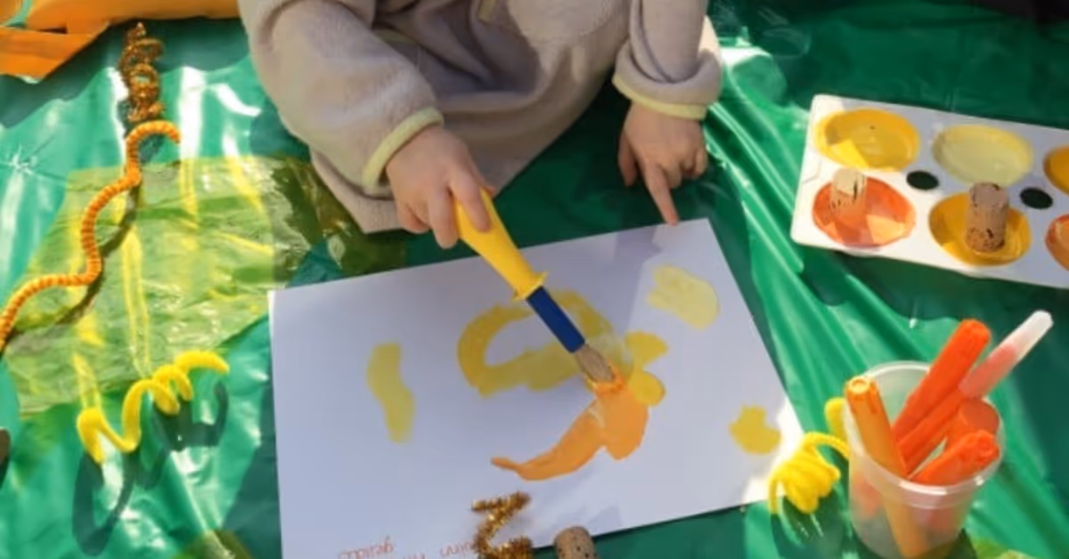 child painting picture using paintbrush