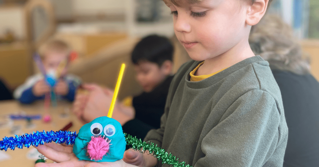 child holding playdough activity