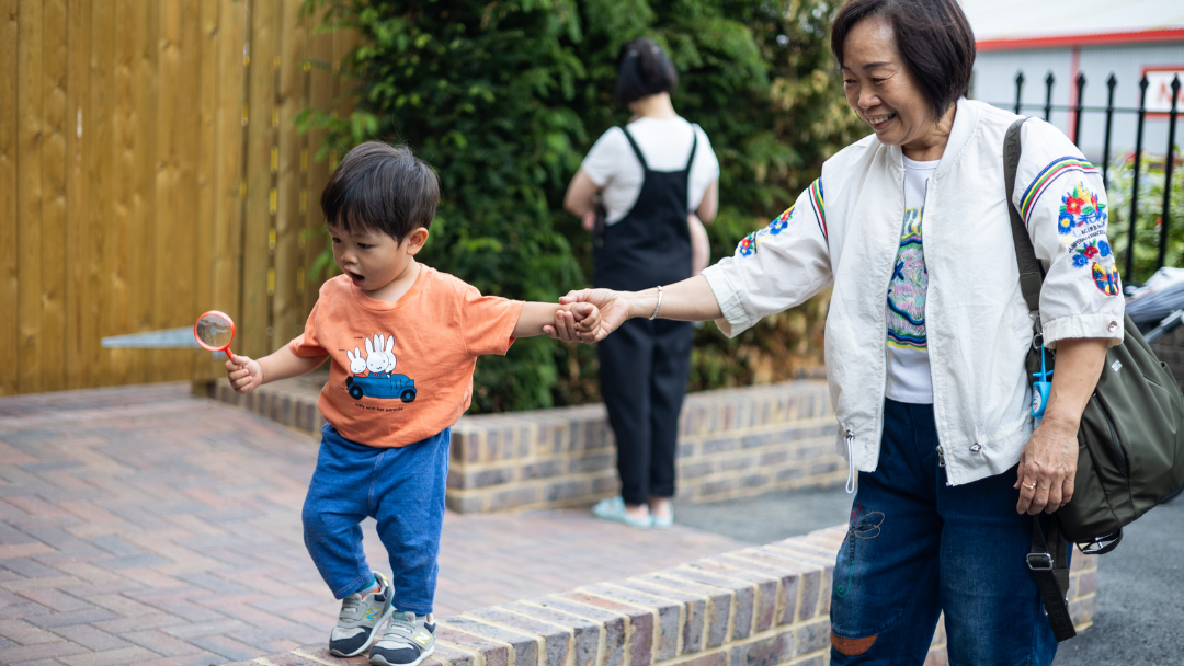 Family member walking with child at Fennies Nursery