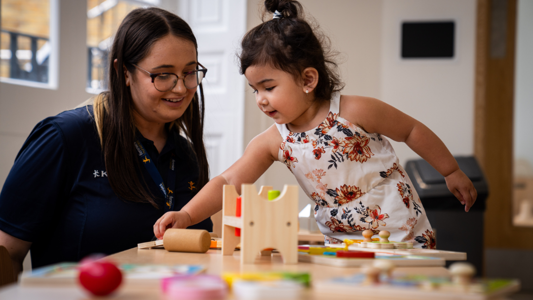 Early Years Educator enjoying an acitivity with a child.