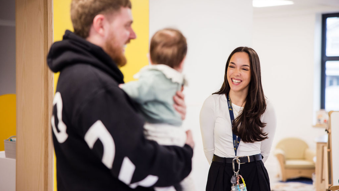 Deputy Manager speaking with a parent and their child.