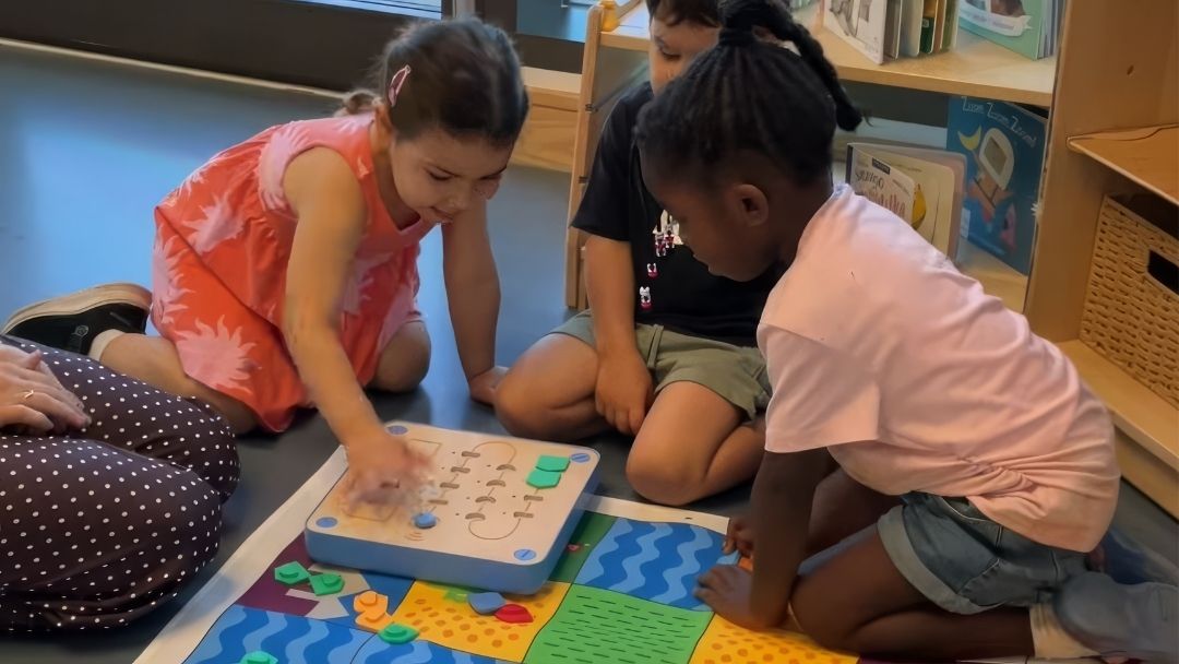 Children playing with Cubetto