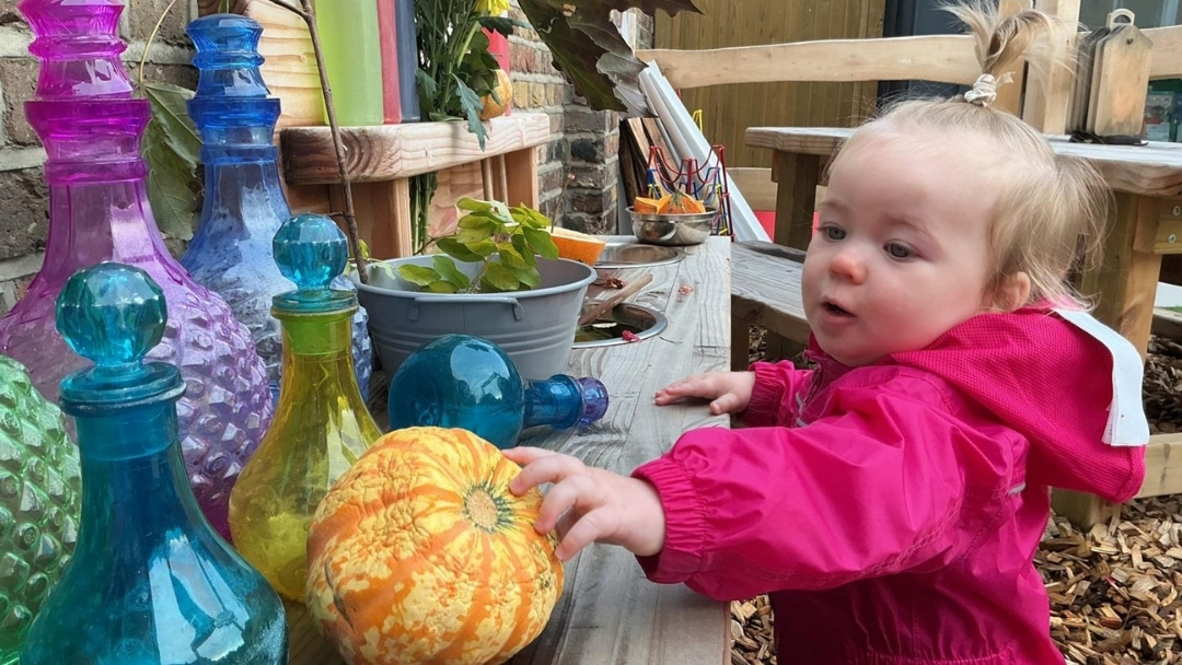 Child playing in the Fennies Mud Kitchen.