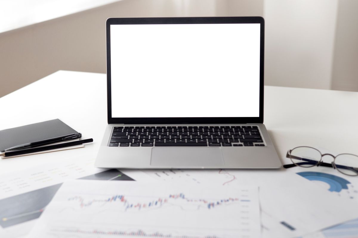Marketer reviewing email campaign analytics on a laptop at a desk